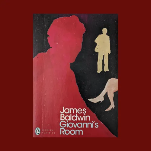 Front cover of giovanni's room by James Baldwin. On a black background, the red silhouette of a man sits in the foreground whilst behind him there are the silhouettes of another man and a woman.