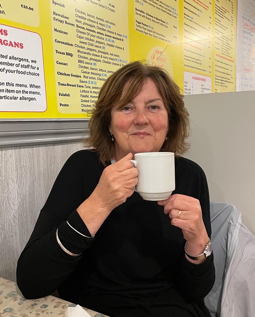 Dee drinks a coffee
